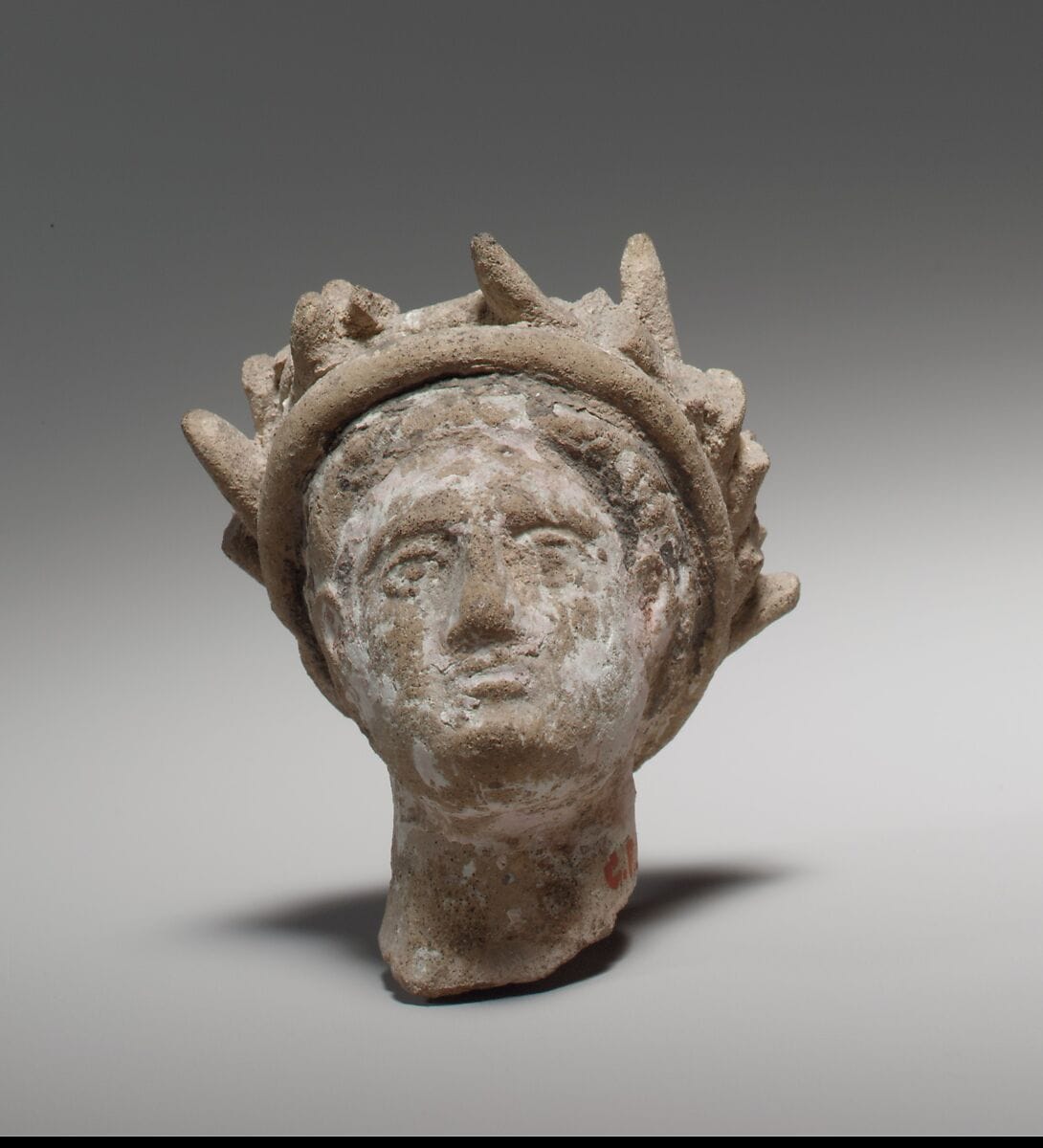 Terracotta male head wearing a wreath - image 1