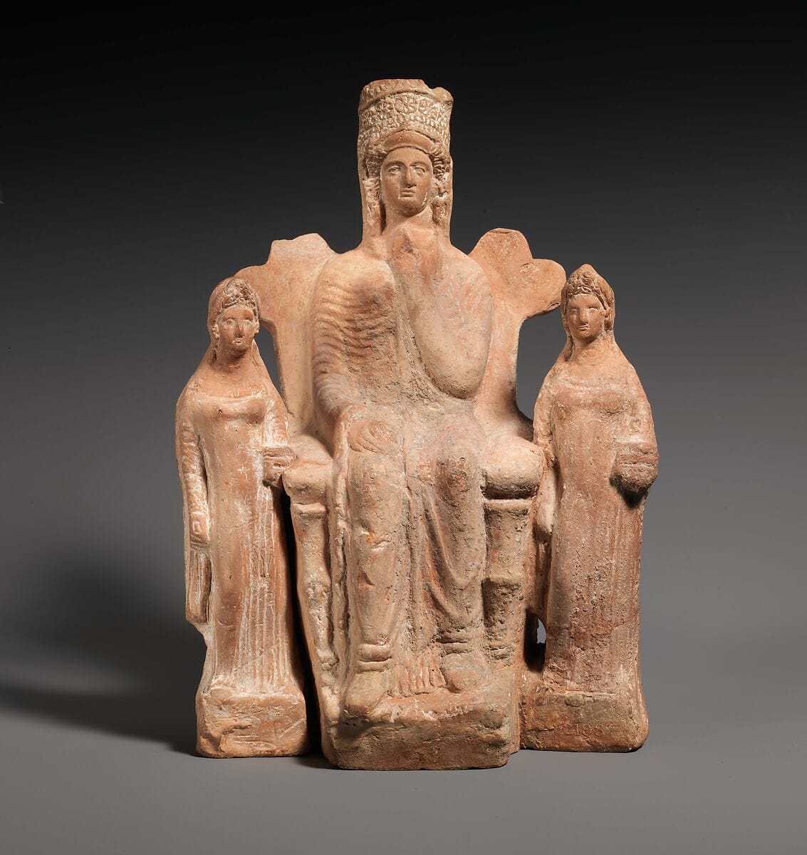 Terracotta statuette of an enthroned goddess between two attendants - image 1