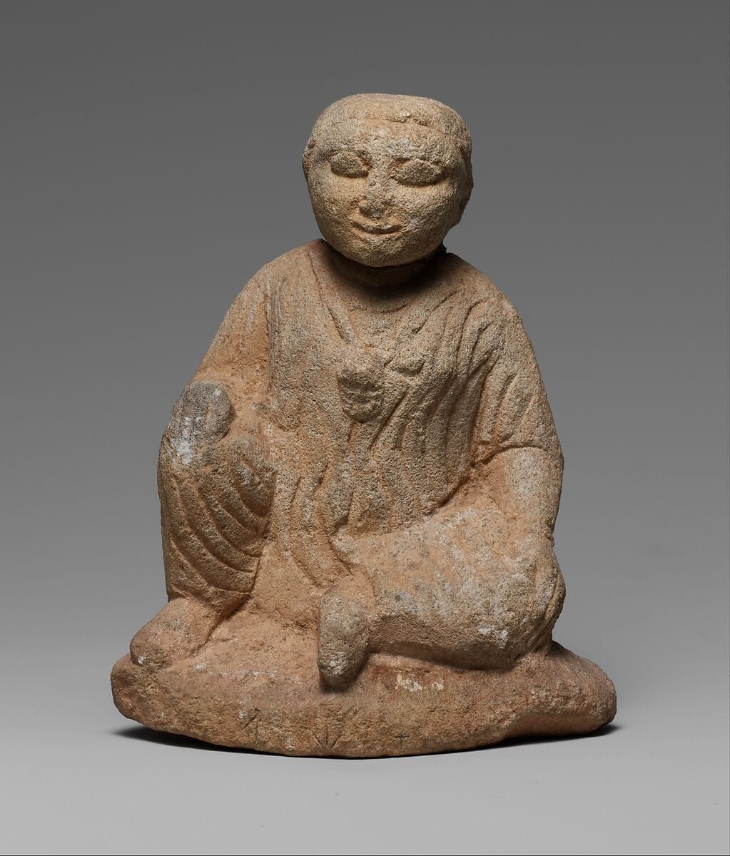 Limestone statuette of a seated temple boy on an inscribed base - image 1