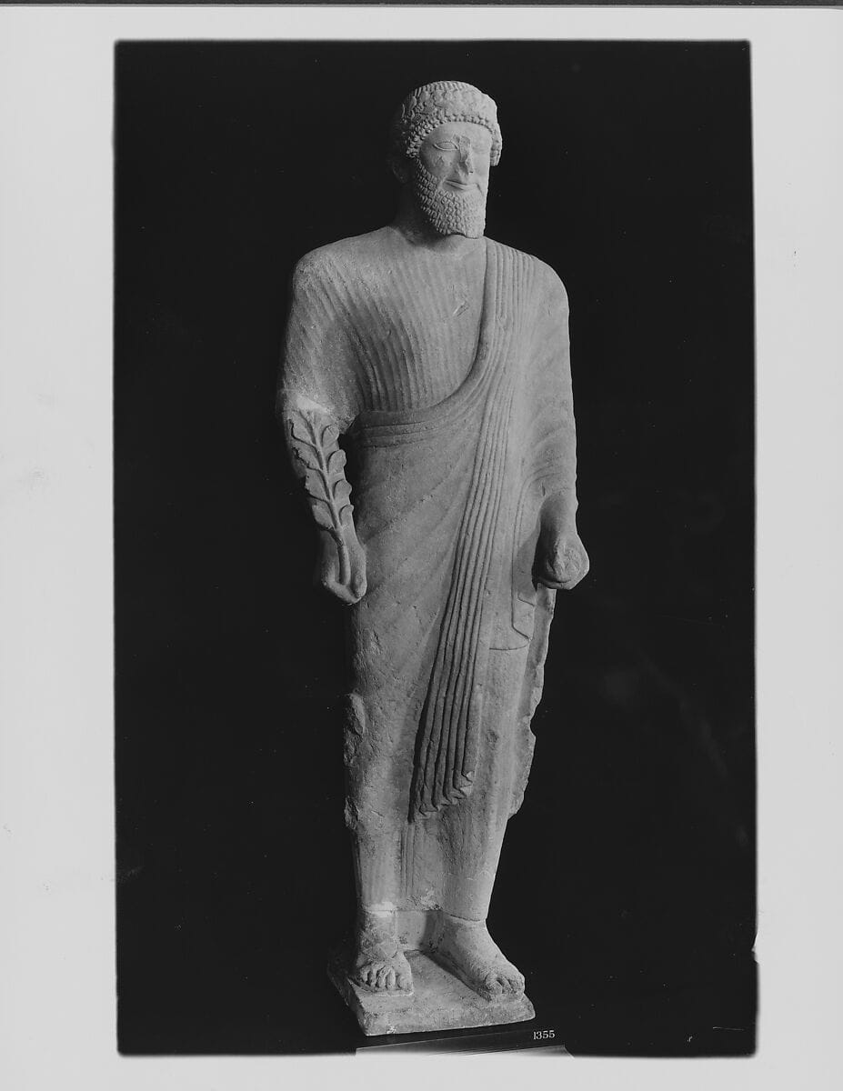 Limestone votary of a bearded male in Greek dress with a wreath - image 1