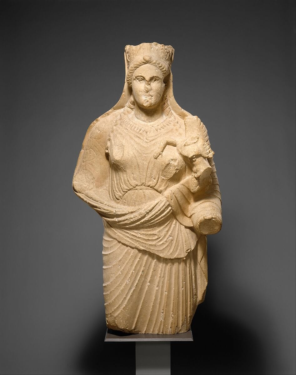 Limestone statue of Aphrodite holding winged Eros - image 1