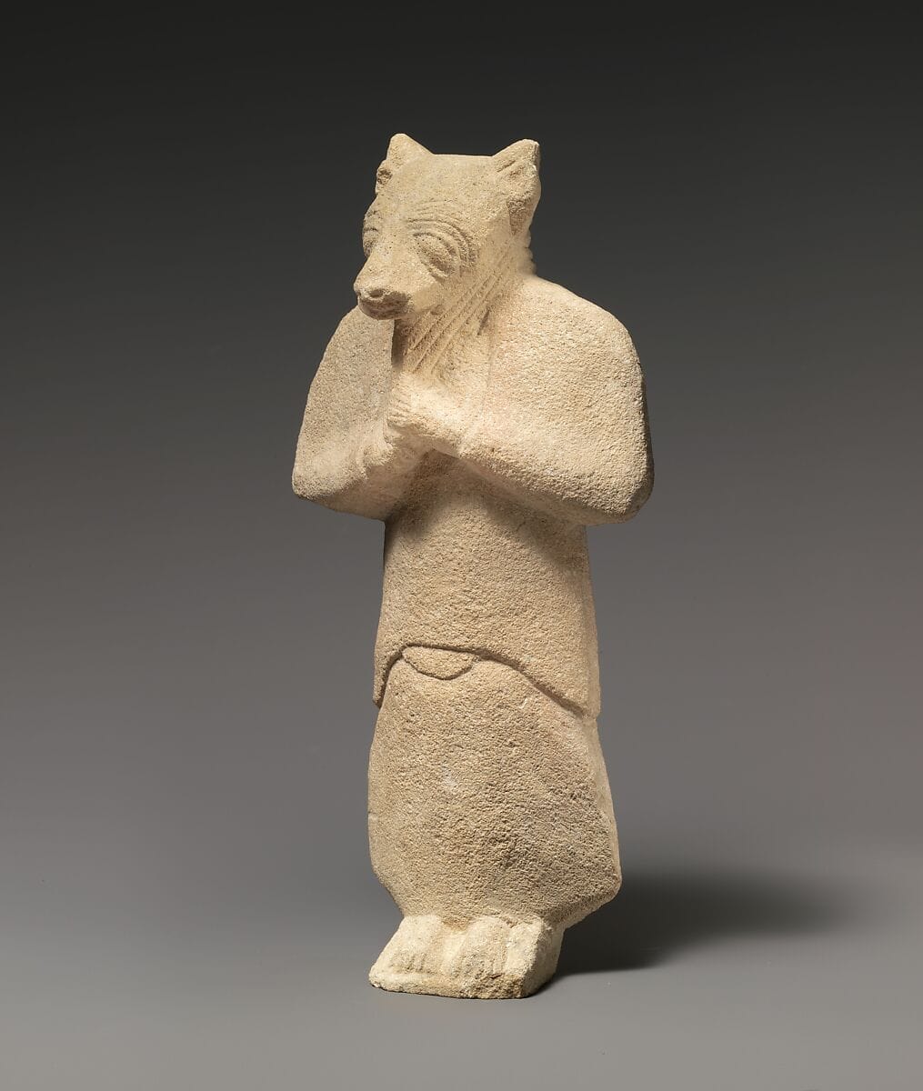 Limestone figure wearing a mask - image 1
