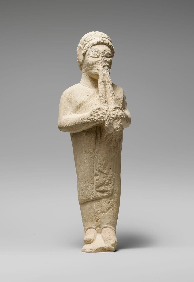 Limestone statuette of a flute-player - image 1