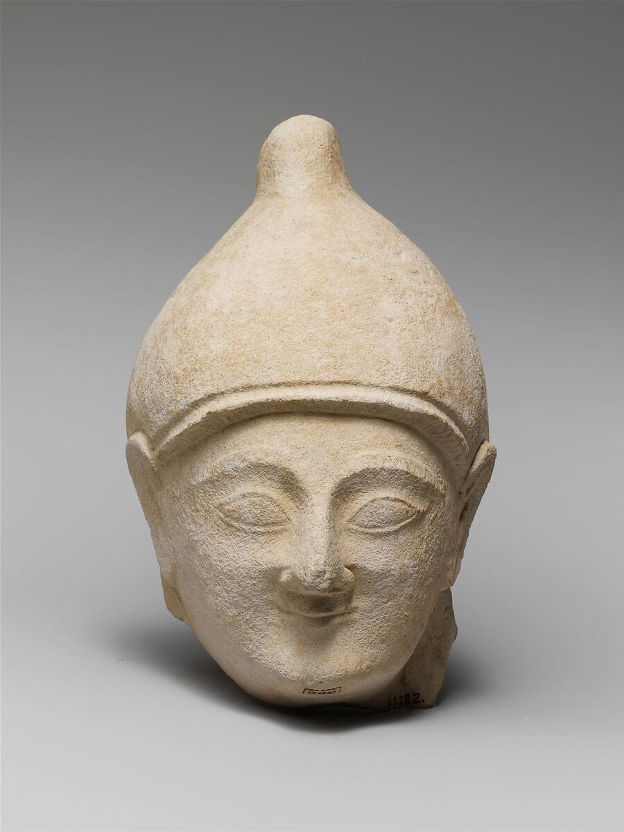 Limestone head of a man wearing a helmet - image 1