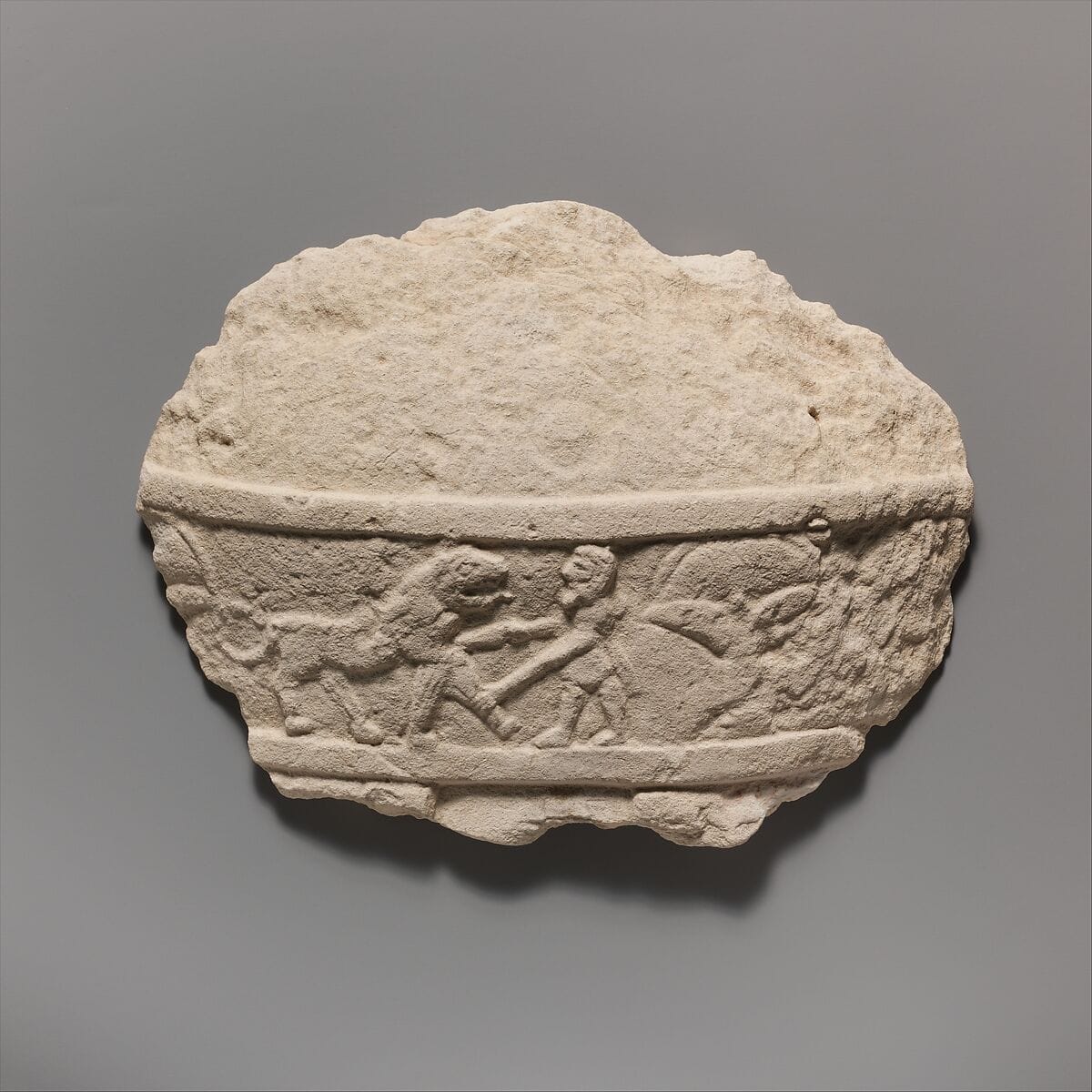 Fragment of a limestone statue of a male votary (worshipper) - image 1