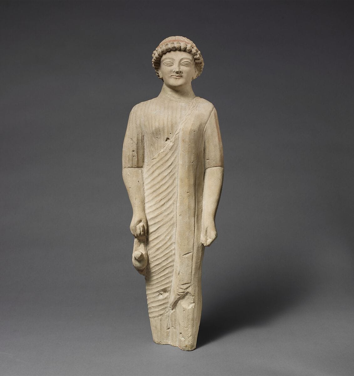 Limestone statuette of a beardless male votary with a fillet - image 1
