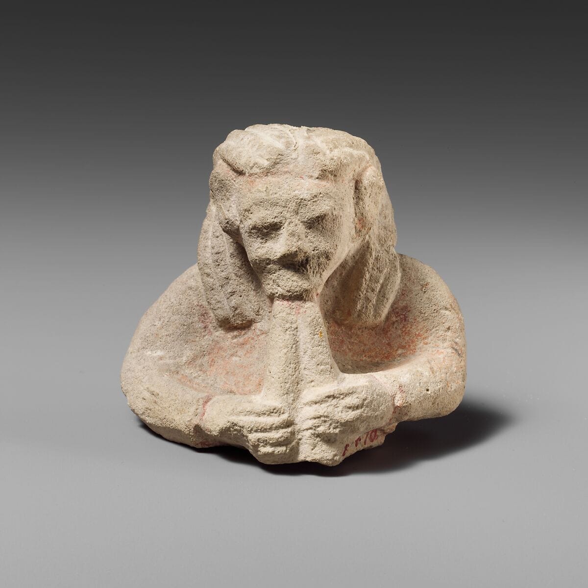Upper part of a limestone male aulos player - image 1