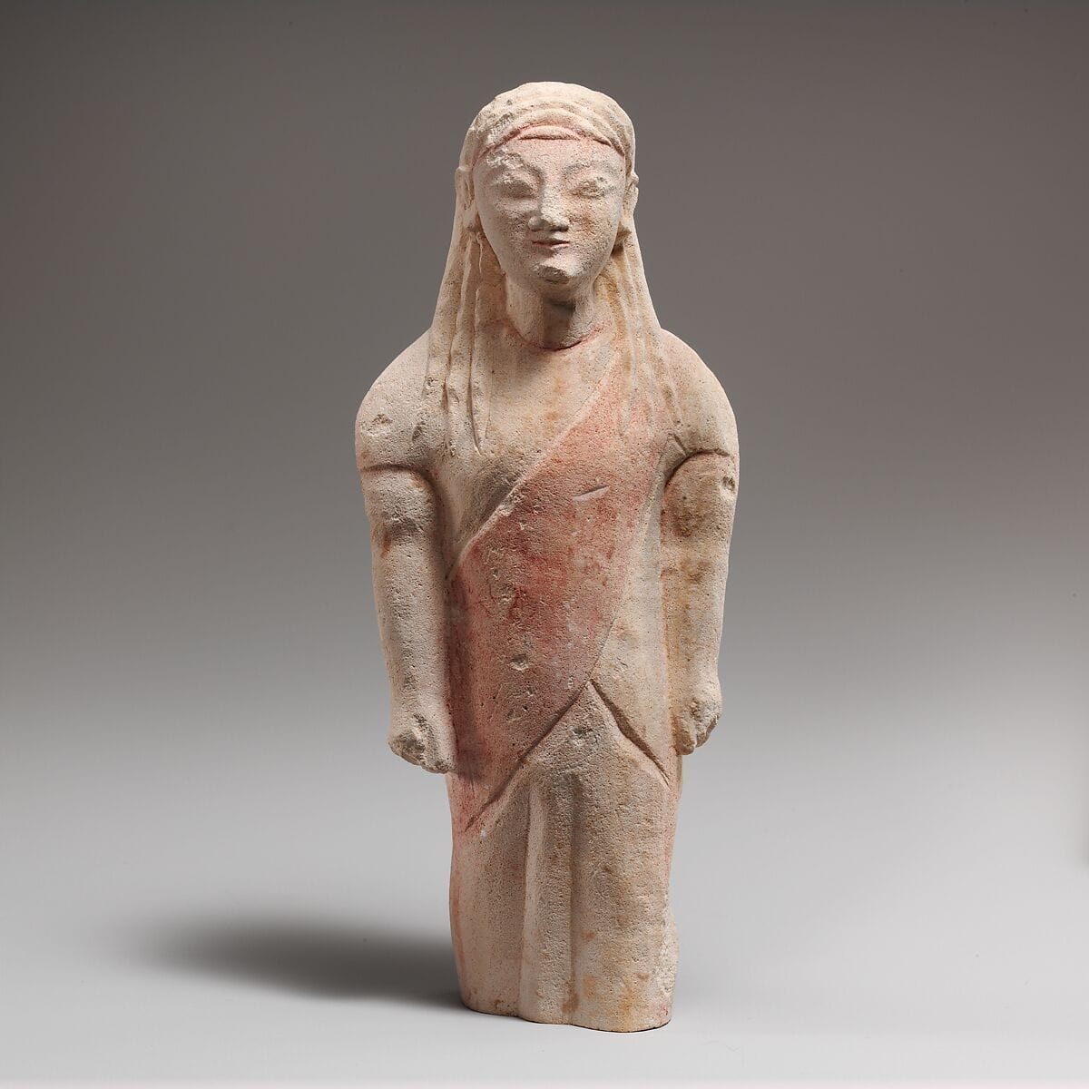 Limestone statuette of beardless male votary in Greek dress - image 1