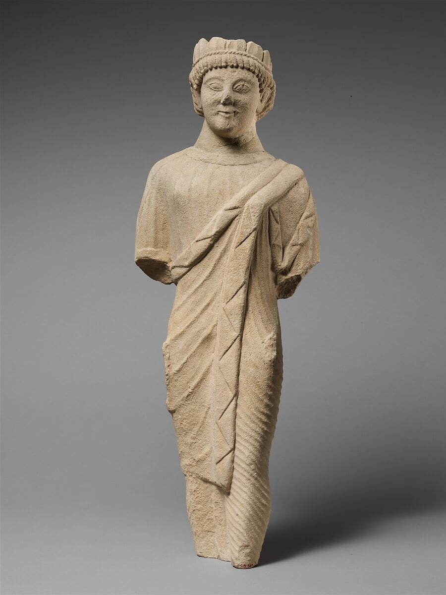 Limestone statuette of a beardless male votary in Greek dress with a wreath of leaves - image 1