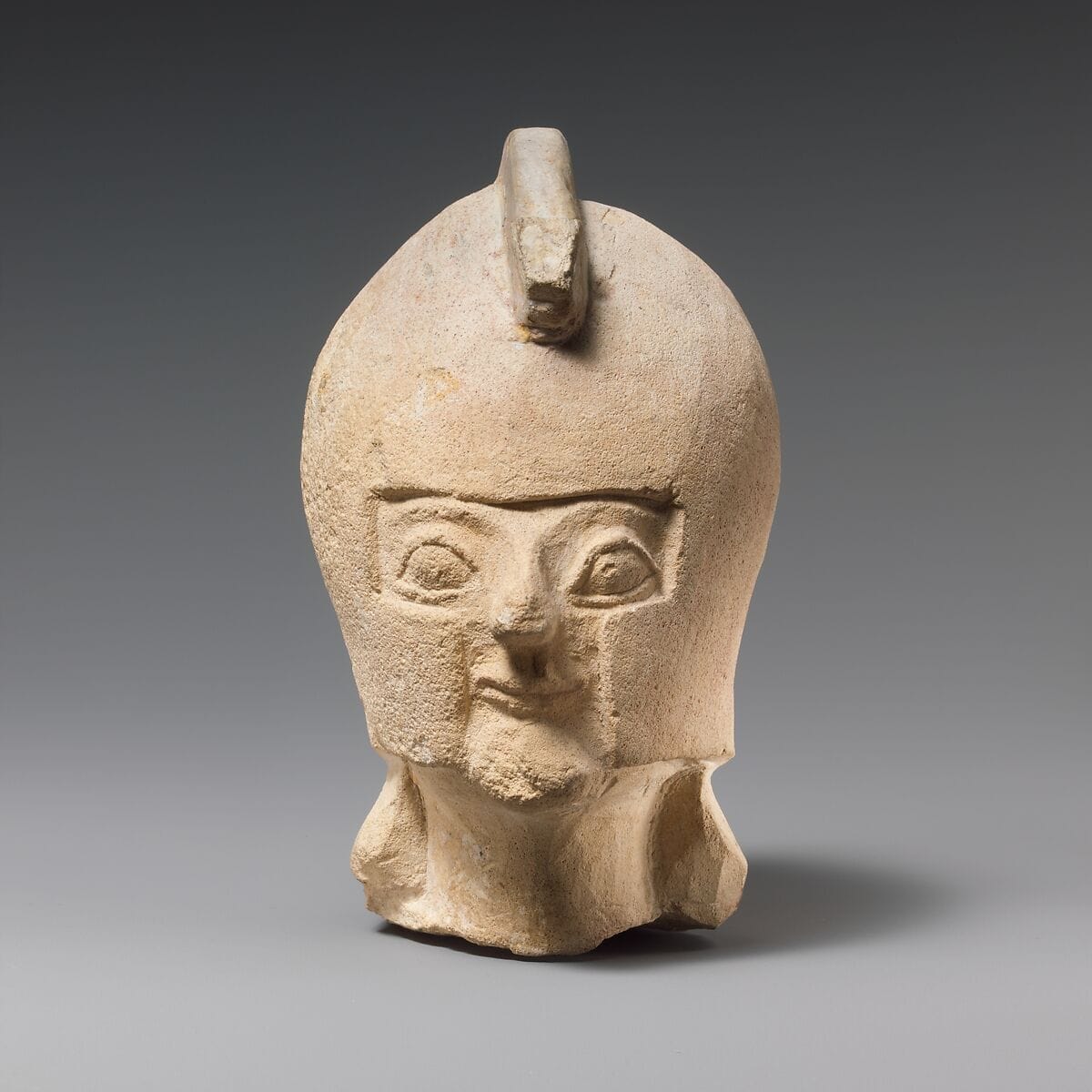 Limestone head of a warrior wearing a crested helmet - image 1