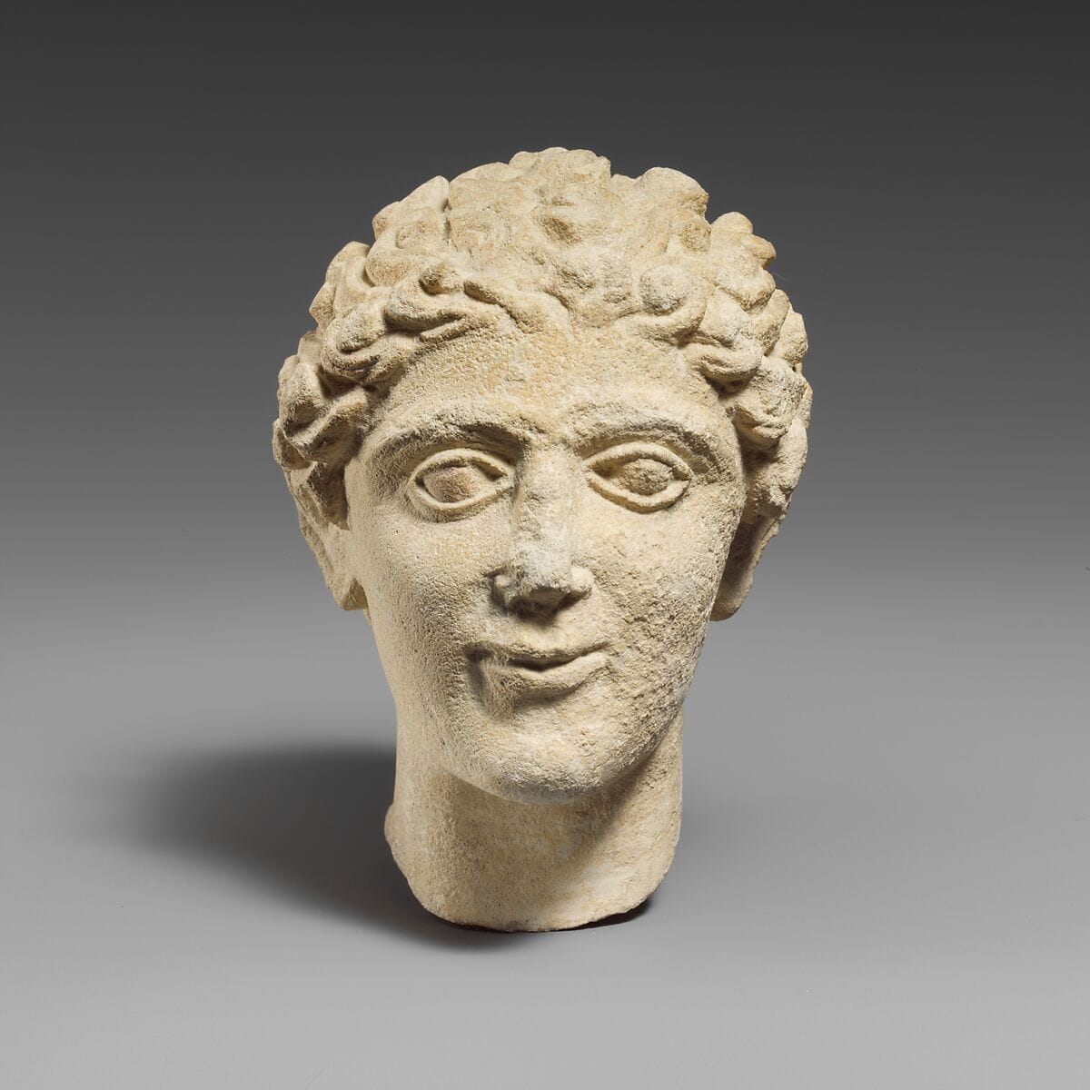 Limestone head of a beardless male votary - image 1