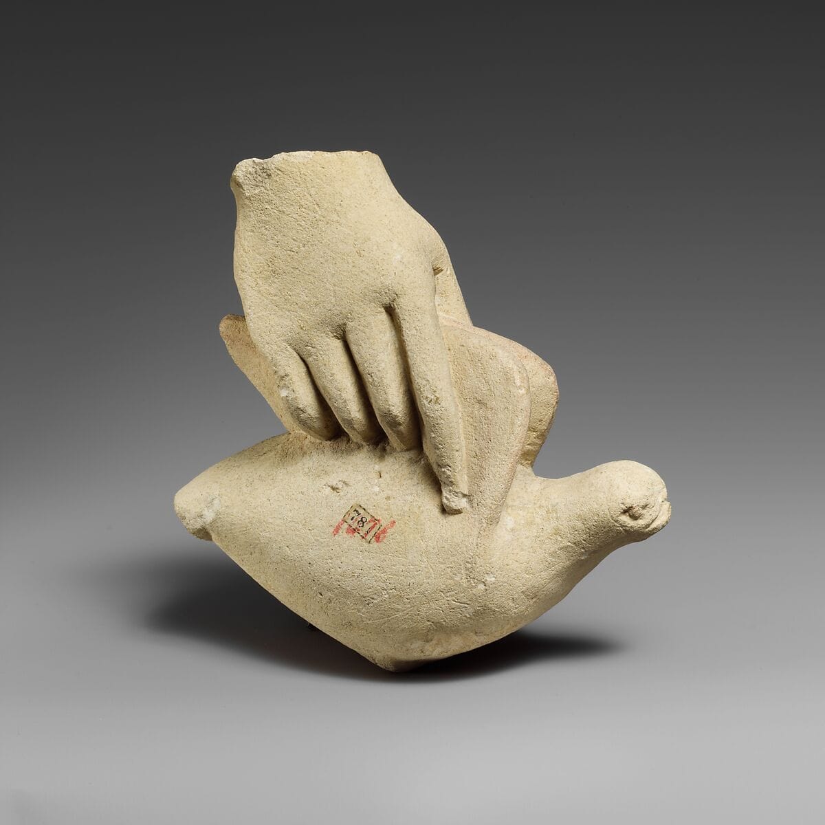 Limestone hand holding a dove - image 1