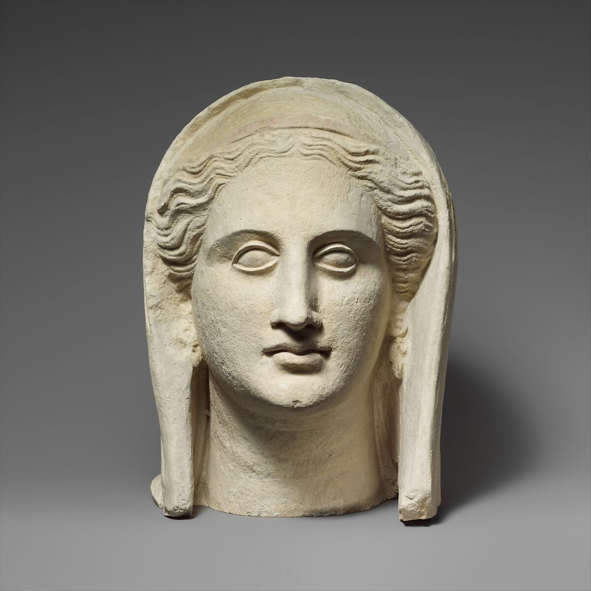 Limestone head of a veiled female votary - image 1