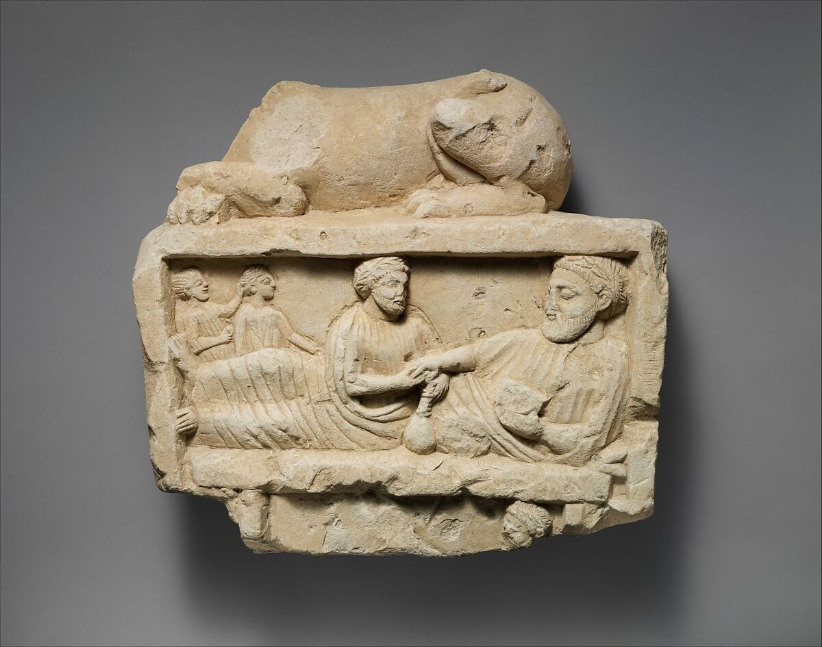 Limestone finial of a funerary stele with a recumbent lion and a banquet scene - image 1