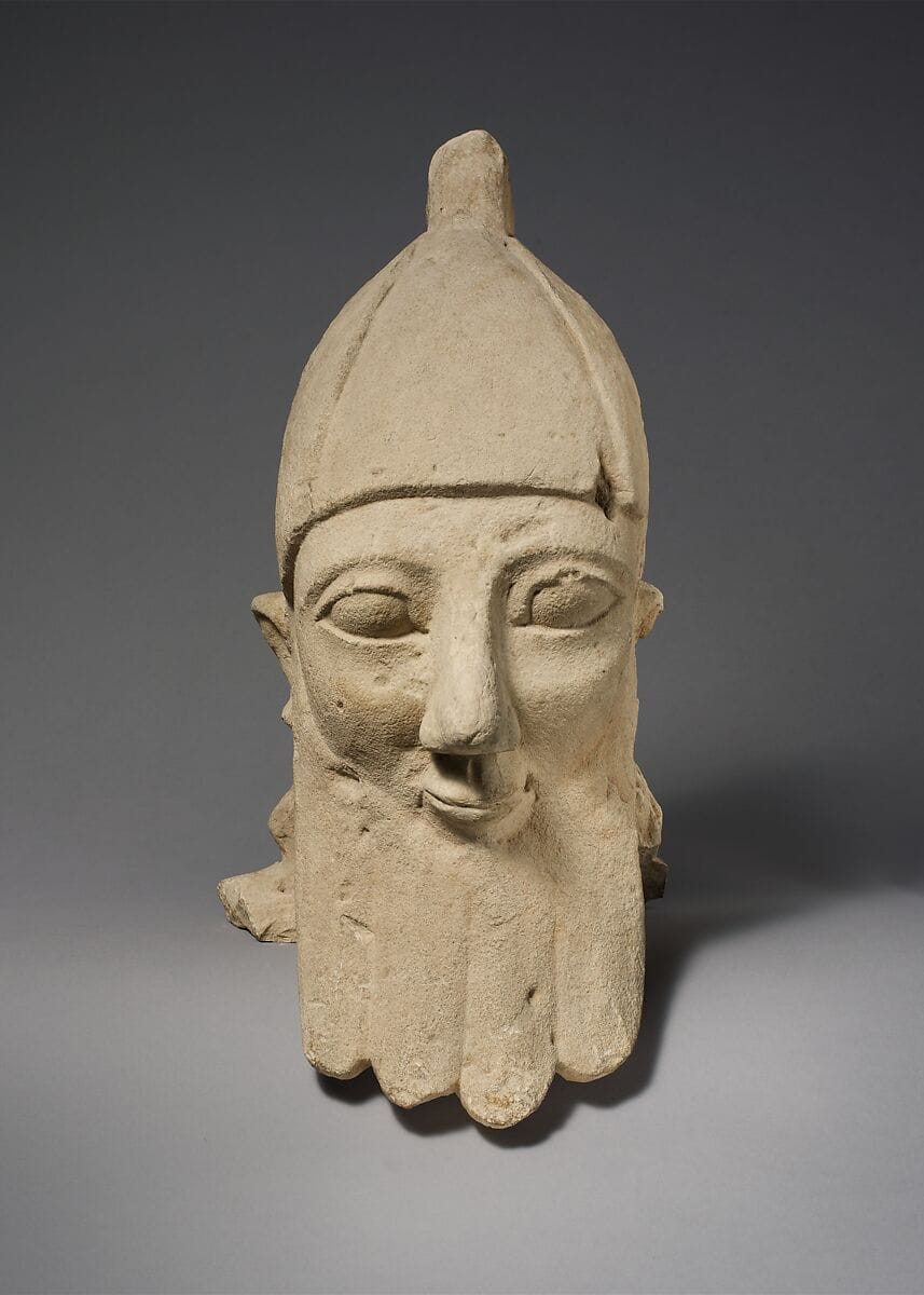 Over-lifesize bearded head wearing a conical helmet - image 1