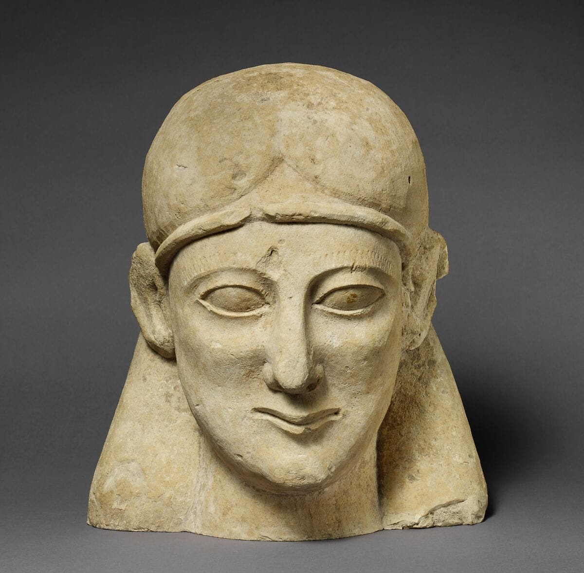Limestone head of a beardless male with a fillet - image 1