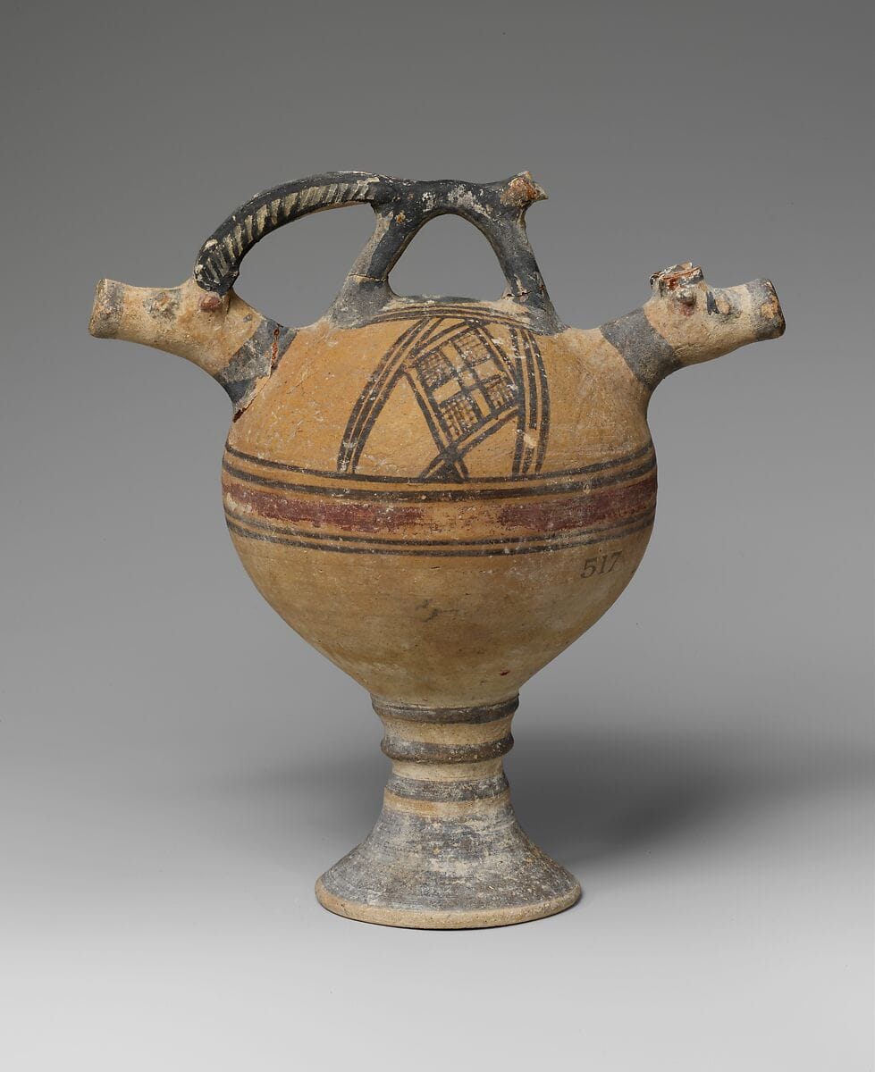 Terracotta vase on a high foot with two goats' heads in relief - image 1